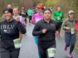 A crowd is in good spirits and smiling while walking and jogging in the Gresham Lilac Run on the Springwater Trail.