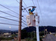 Utility worker in a Cherry Picker replacing a street light. 