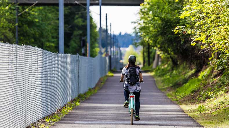Bike riding along the Wy'East Way multi-use path through the heart of Civic Neighborhood.