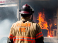 Firefighter observing a sprinkler demonstration