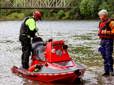 Two Gresham firefighters performing a water safety demonstration