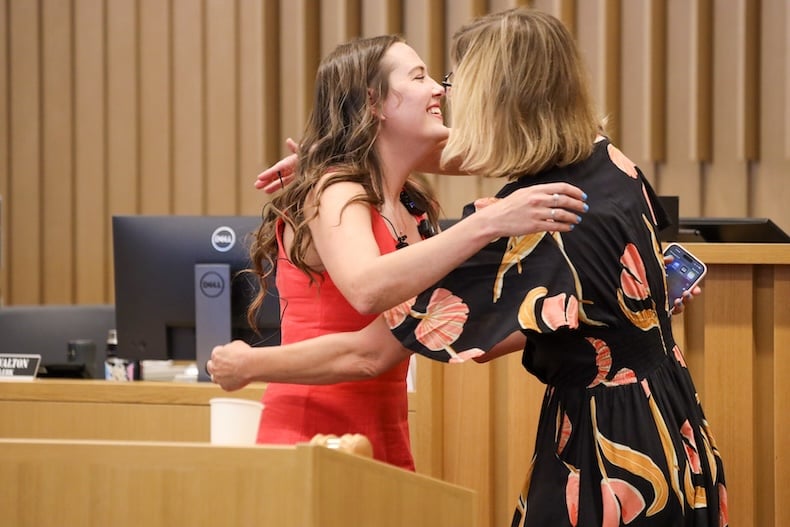 Wearing a wide smile, Autumn Booth throws her arms around the judge.