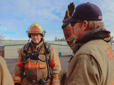 A fire recruit listens intently as his instructor explains the next training exercise.