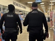 Two officers entering a store during a retail theft mission.