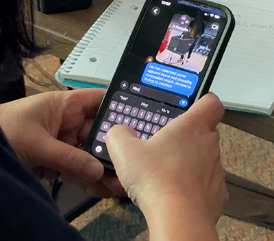 Customer Support Specialist's phone with text messages to retail stores. 