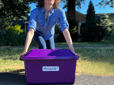 Person holding a recycle bin