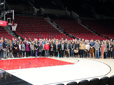 Group of Green Business participants gather on the basketball court, for a tour of Portland's Moda Center