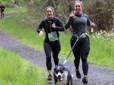 Runners move along a green, forested trail during the Gresham Lilac Run.