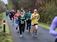 Women smile and wave while jogging along the Springwater Trail for the Gresham Lilac Run.