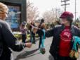 People celebrate getting their Gresham Lilac Run medals at the finish line.